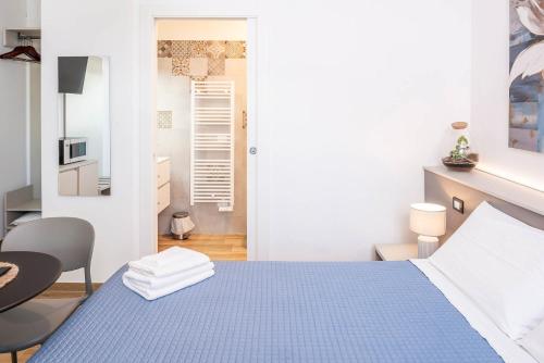 a bedroom with a blue bed and a chair at L'angolo del Forte in Rivoli Veronese
