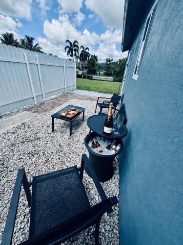 a patio with two chairs and a table and a grill at 2 bed peaceful, lakeview studio NO FEES in Atlantis