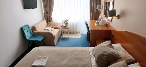 a hotel room with a bed and a chair at Alka guest house in Palanga