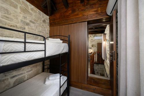 two bunk beds in a room with a stone wall at Villa Diamant 1860 in Monókhoron