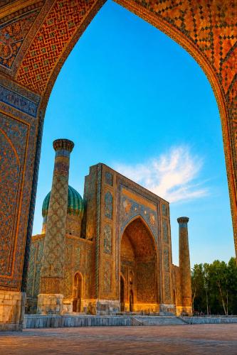 a building with an arch in front of it at Registan Stay in Samarkand
