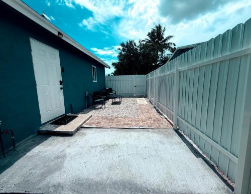 a driveway with a white door and a fence at 2 bed peaceful, lakeview studio NO FEES in Atlantis
