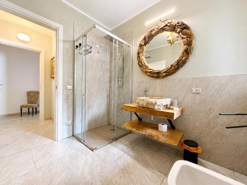 a bathroom with a shower and a sink and a mirror at Villa dei Mumi in Luino