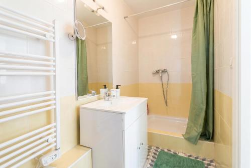 a white bathroom with a sink and a shower at Quiet and bright studio in Gorze in Gorze