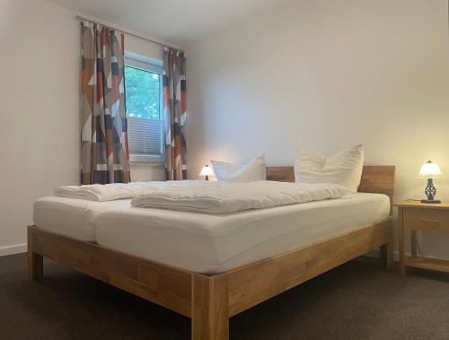 a bed with white sheets and pillows in a bedroom at Haus Fünfschläfer in Dreschvitz