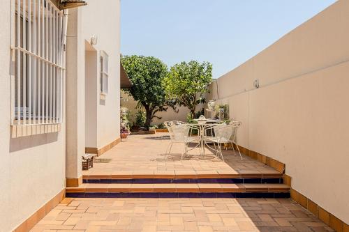 a balcony with a table and chairs on a patio at De la Danza in Seville