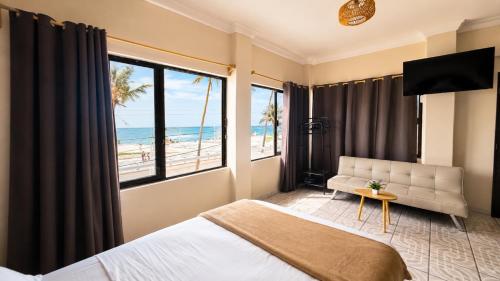 a bedroom with a bed and a view of the beach at Suites Puerto 201 in Veracruz