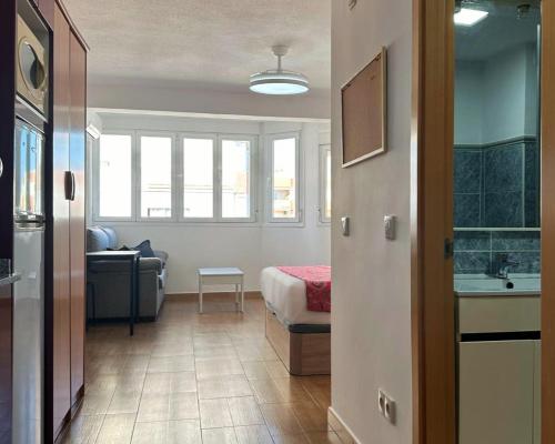 a room with a bed and a couch and a sink at Brisa de Torre in Torre del Mar