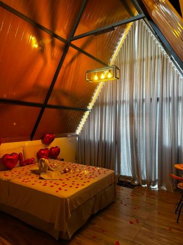 a room with a bed with flowers on it at Chalés JH Serra da Canastra in São Roque de Minas