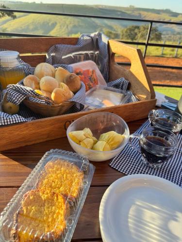 a table with a tray of food on a table at Chalés JH Serra da Canastra in São Roque de Minas