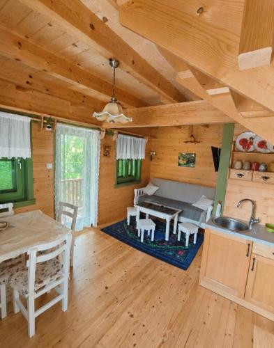 a kitchen and dining room of a log cabin at STD Bešević "Naše Brdo" Ivanjica in Ivanjica