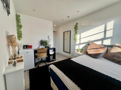 a bedroom with a king sized bed and a desk at The Grove Sutton in Sutton