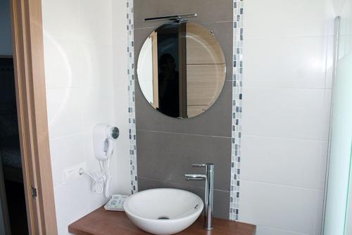 a bathroom with a white toilet and a mirror at Hostal Montilla Sotogrande in Torreguadiaro