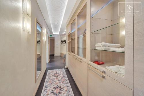 a hallway with wooden cabinets and a rug at Boutique Flat - Spa Shower - Sound System in Tallinn