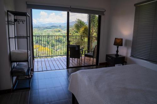 a bedroom with a bed and a balcony with a view at Cabaña El Sargento in San Francisco
