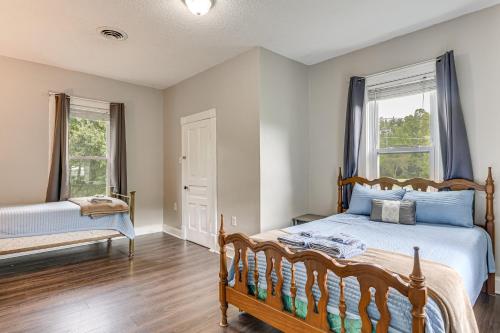 a bedroom with a bed and two windows at Mtn Views & Idyllic Setting! Clifton Forge Retreat in Clifton Forge