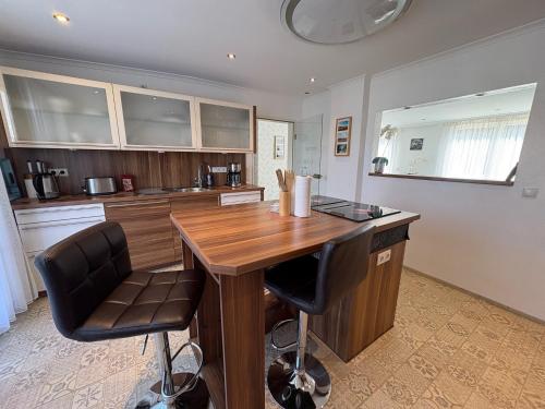a kitchen with a wooden table and two chairs at Ferienhaus Nehring in Bad Neuenahr-Ahrweiler