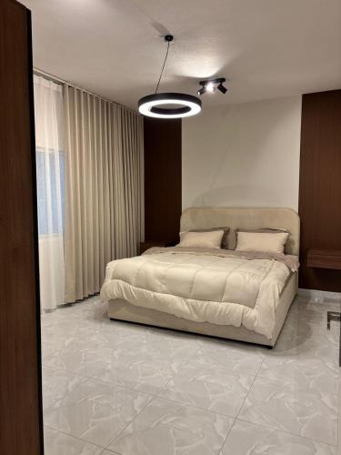 a bedroom with a large bed in a room at Bloom Home in Al Khobar