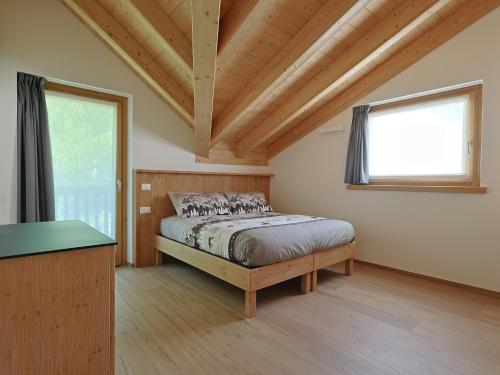 a bedroom with a bed and a window at Bormio BM0 - Tutta Bormio a Zero stress in Bormio
