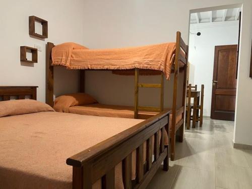 a bedroom with two bunk beds and a doorway at Espacio493 in Villa Gesell