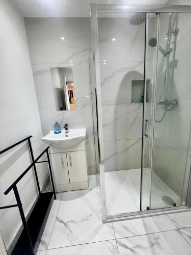 a bathroom with a shower and a sink at Sutton & Stone in Sutton
