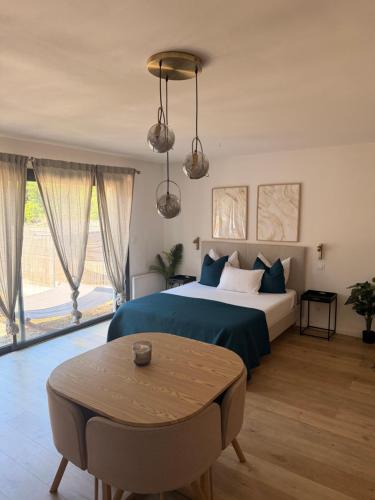 a bedroom with a large bed and a table at Suite Canne Or in Bommes