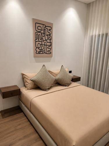 a bedroom with a bed with pillows on it at A Suites in Casablanca