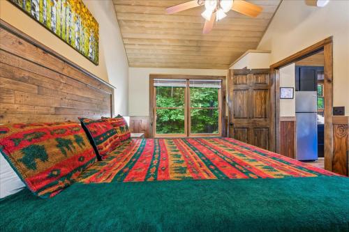 a bedroom with a large bed with a wooden headboard at Summit View by Venture Smoky Mountains in Sevierville