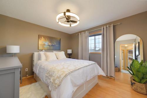 a bedroom with a bed and a ceiling fan at Lake Life Landing in Sylvan Lake