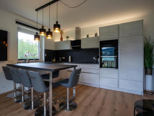a kitchen with a dining room table and chairs at RABENSTEINER - Panorama Apartments - Bad Kleinkirchheim in Bad Kleinkirchheim