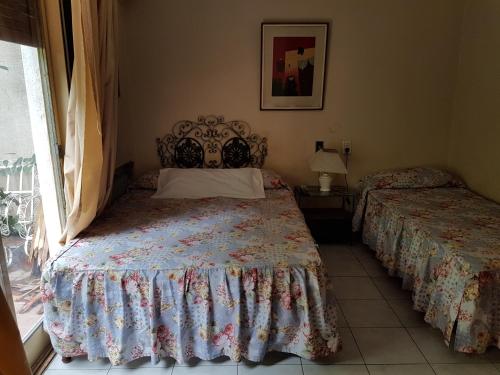 Postel nebo postele na pokoji v ubytování Nuevo Castillo Hotel