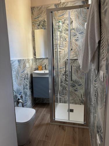 a bathroom with a shower and a toilet and a sink at Casa Agata in Chioggia