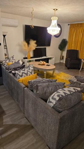 a large couch in a living room with a table at North in Camby