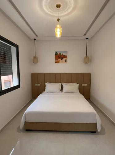 a bedroom with a large bed in a room at Spinoza House Agadir City Apartment in Agadir