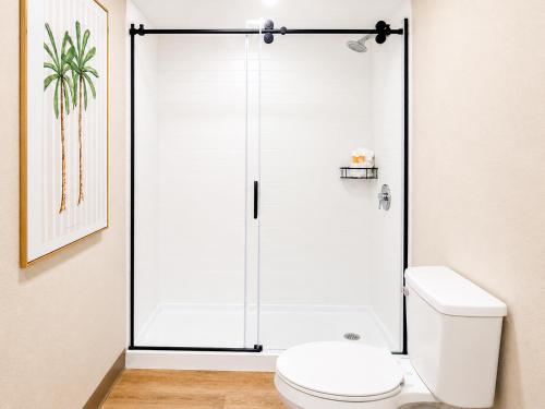 a shower stall in a bathroom with a toilet at Palm & Tide Beachfront Hotel in Panama City Beach
