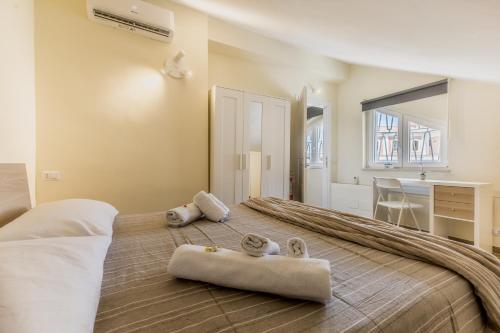 a bedroom with a large bed with towels on it at Fly&Rest Ciampino in Ciampino
