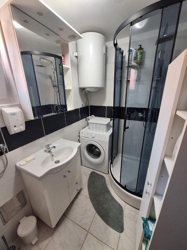 a bathroom with a toilet sink and a shower at Apartment Lela - self check-in and check-out in Otočac
