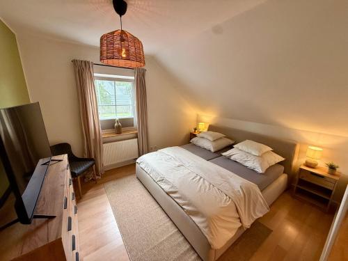 a bedroom with a bed and a window at Haus Muhblick in Schmallenberg