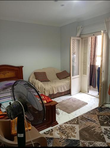 a room with a bed and a fan in it at شقة سوبر لوكس ثلاث غرف بعين شمس الشرقية in Cairo