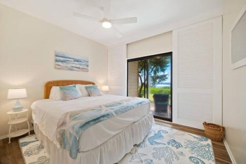 a bedroom with a bed and a large window at Makai Dream (Oceanfront) in Lihue