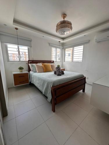 a bedroom with a bed with a cat sitting on it at The Liras Oasis in Santiago de los Caballeros