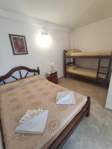 a bedroom with two beds with towels on them at Hospedaje Dos Soles - Centro in Termas de Río Hondo
