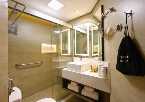 a bathroom with a sink and a shower at Radisson Oscar Freire in São Paulo