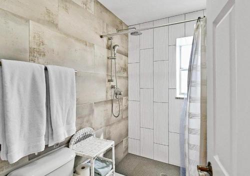 a white bathroom with a shower and a toilet at Bay view Siesta Key condo - two pools - tennis and pickleball - beach access - GBB 1343 in Siesta Key