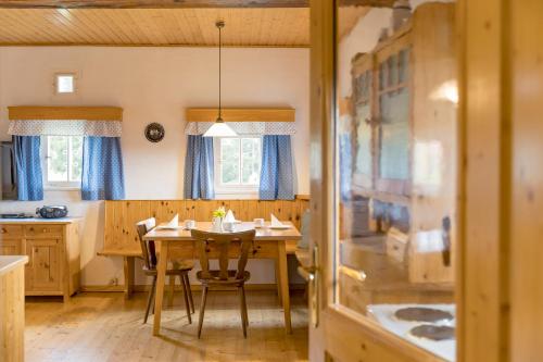 a kitchen with a table and chairs in a room at Biobauernhof Gegg in Schwanberg