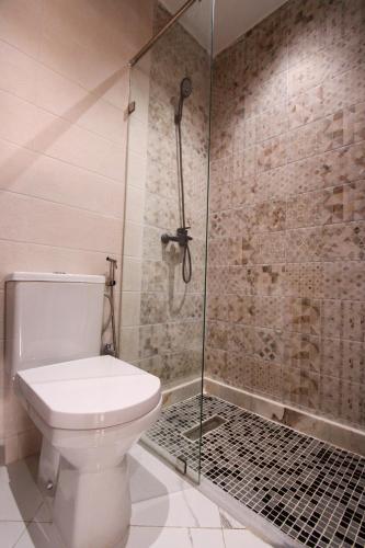 a bathroom with a toilet and a glass shower at Marina plage in Kenitra