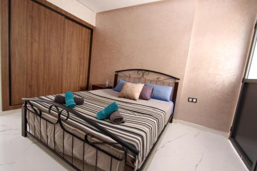 a bedroom with a bed with pillows on it at Marina plage in Kenitra