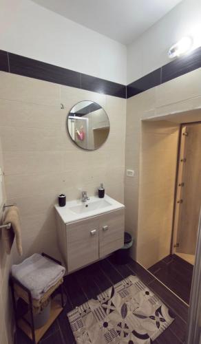 a bathroom with a sink and a mirror at AG Scalo d amore house in Naples