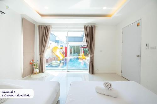 a bathroom with a tub and a swimming pool at Scarlet Poolvilla Pattaya in Na Jomtien
