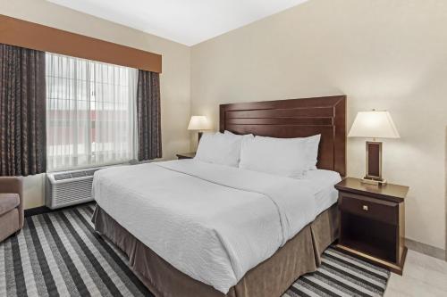 a hotel room with a large bed and a window at Best Western Plus Meridian in Lloydminster